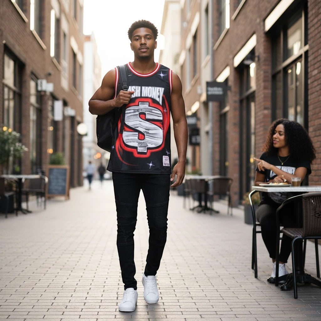 Throwback Rack Cash Money Records black basketball jersey with dollar sign graphic and red/white trim. Model wears it with black jeans and white sneakers.