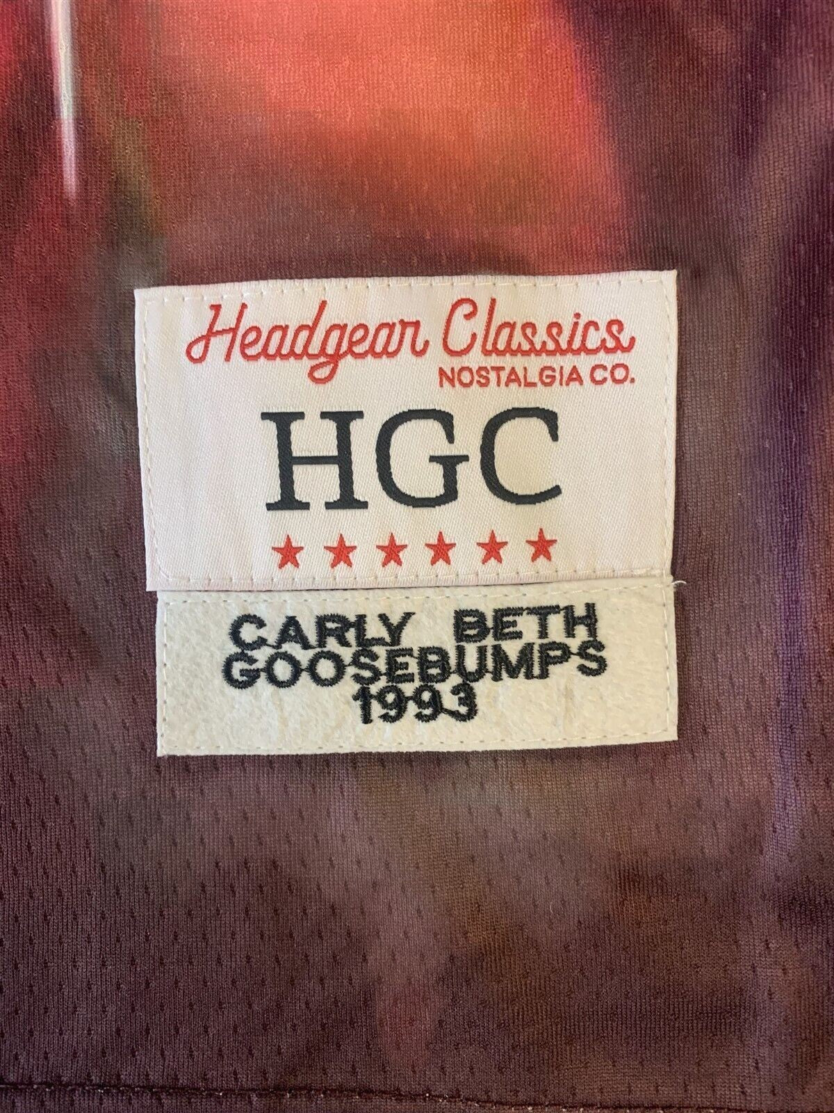 Throwback Rack Headgear Classics woven label on a Goosebumps Carly Beth basketball jersey with mesh fabric detail