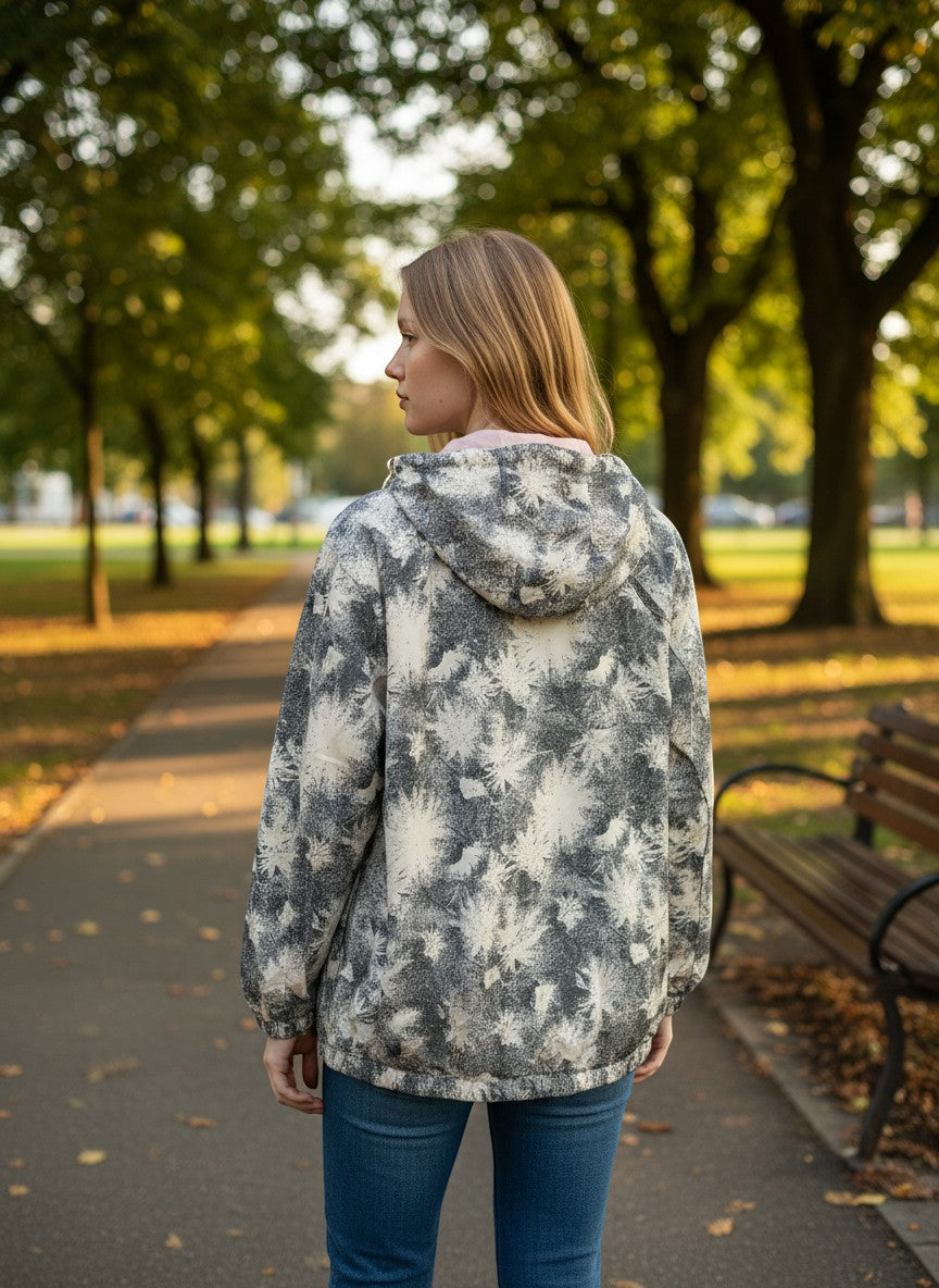 Throwback Rack Levi's Claremont Utility Jacket in grey and white abstract print with hood. Model wears jeans in a park setting.