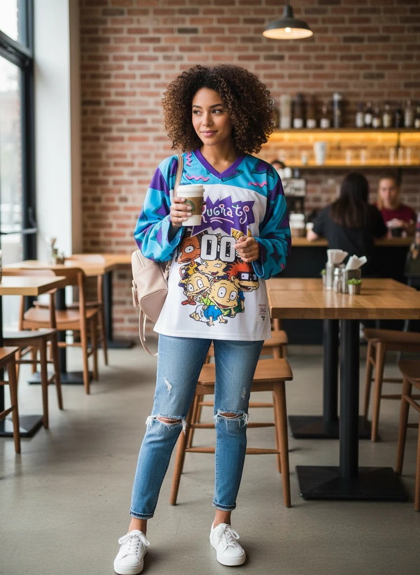 Throwback Rack Rugrats Reptar hockey jersey with V-neck, white, purple, and teal geometric sleeves, featuring the Rugrats characters and Reptar graphic.