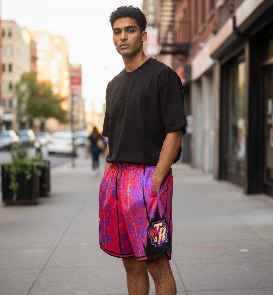 Throwback Rack Toronto Raptors basketball shorts in red and purple with a lightning bolt pattern and team logo on the side. Made of 100% polyester.