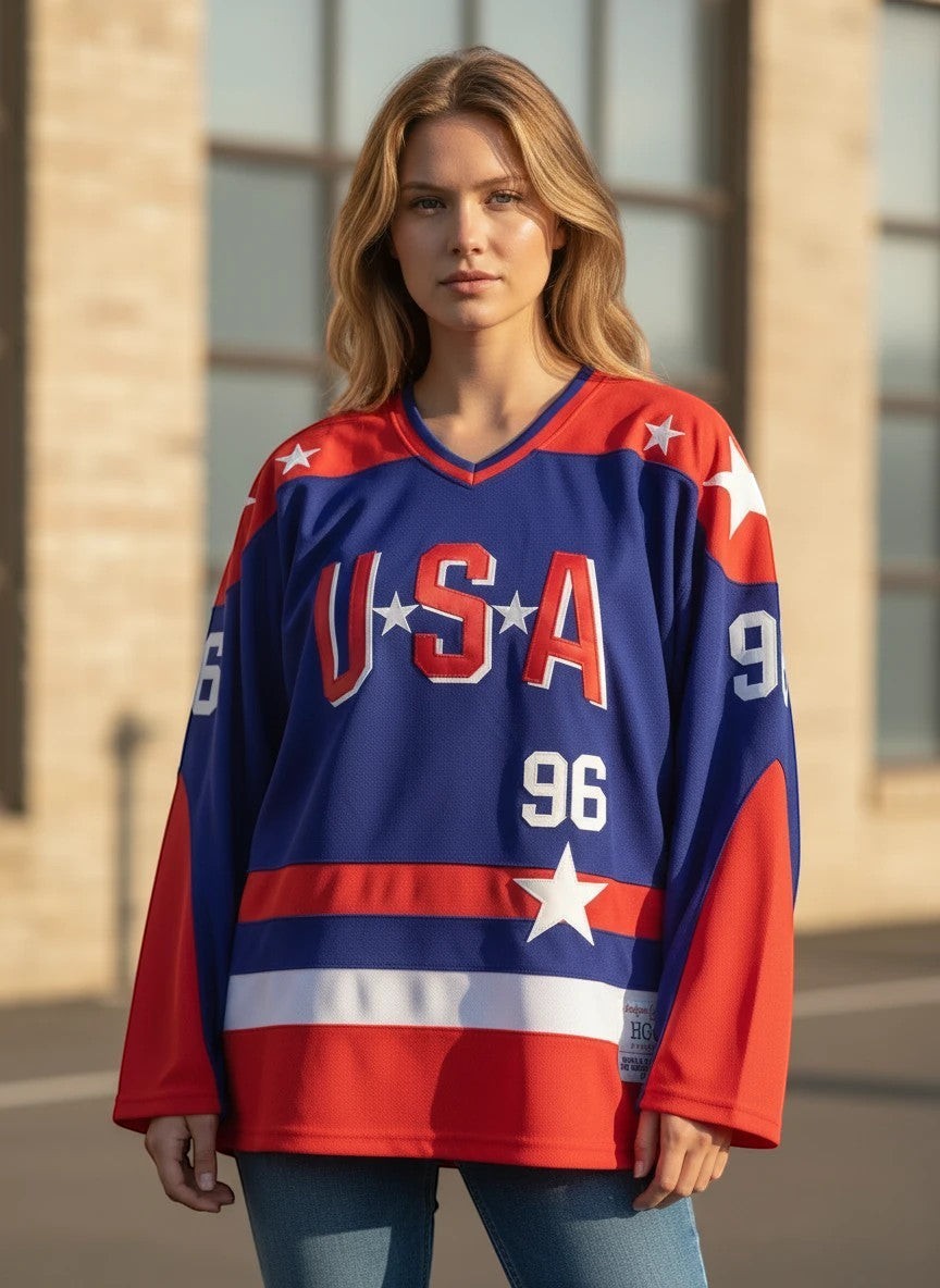 Throwback Rack blue USA Hockey Jersey with red sleeves, stars, and "96" Conway design. Model wears jeans.