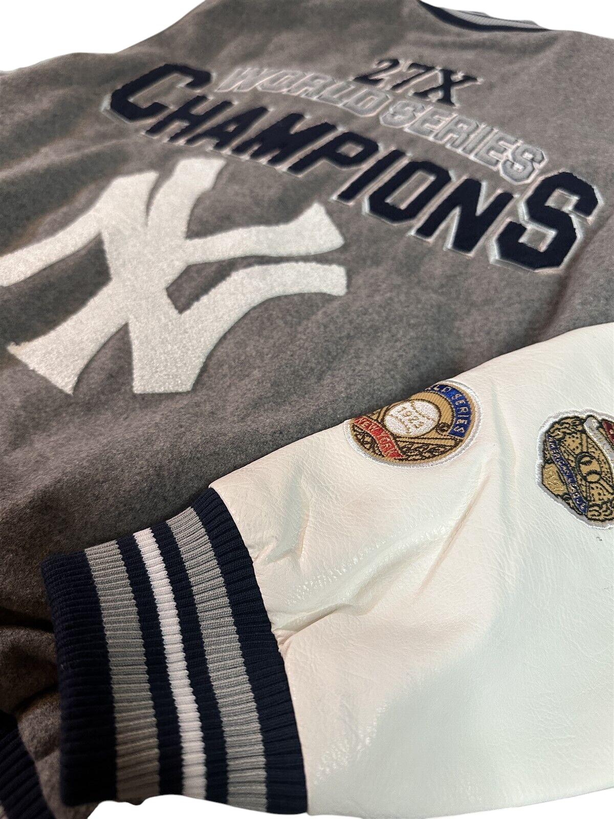 Throwback Rack New York Yankees G-III varsity jacket with grey twill body, white faux leather sleeves, and patches.