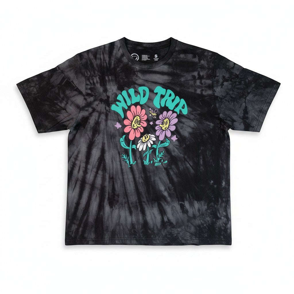 Throwback Rack black tie-dye t-shirt with a graphic of "Wild Trip" text above smiling flowers and a butterfly. Made of cotton.