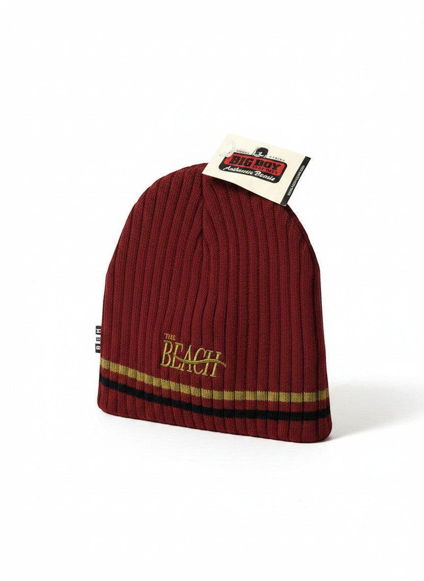 Throwback Rack burgundy knit beanie with "The Beach" embroidered in gold and striped band.