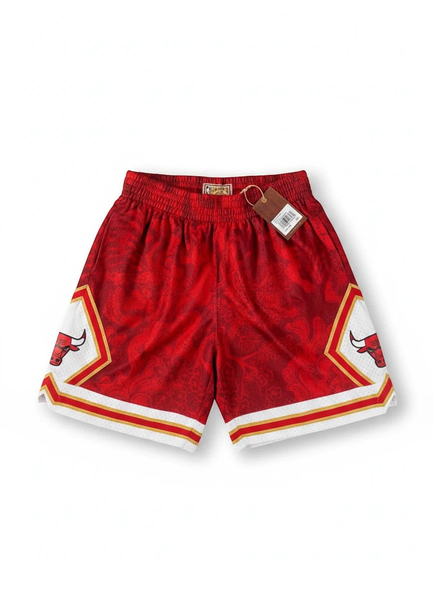 Throwback Rack Chicago Bulls Mitchell & Ness red mesh basketball shorts with paisley pattern and team logo.