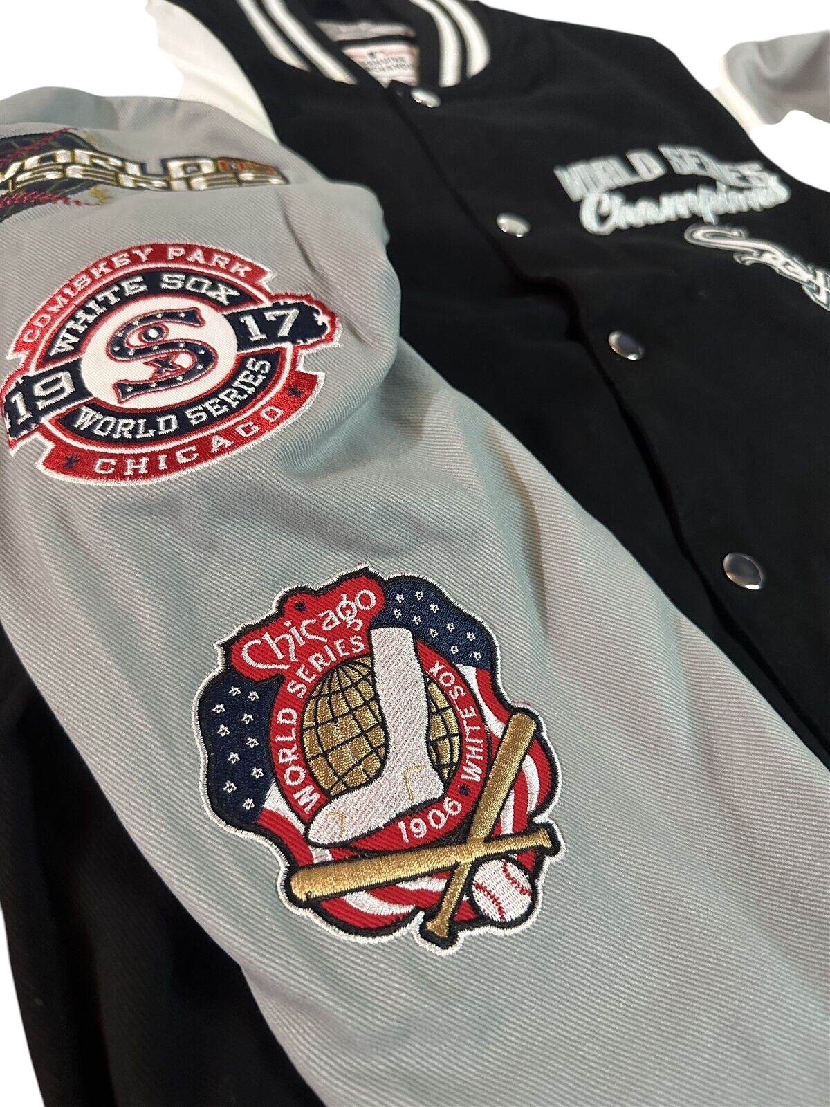 Throwback Rack Chicago White Sox varsity jacket with embroidered World Series patches on grey sleeves and black body.
