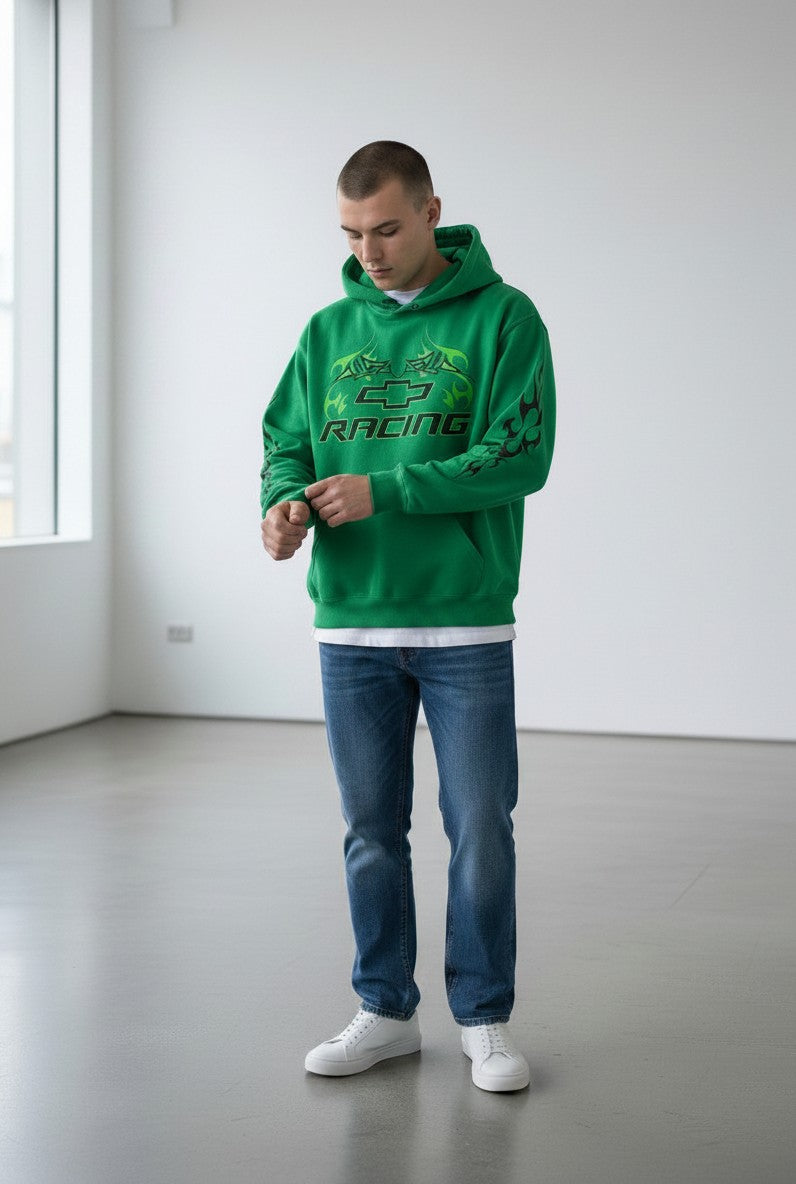 Throwback Rack green Chevrolet Racing hoodie with black flame graphics worn by a man with blue jeans and white sneakers