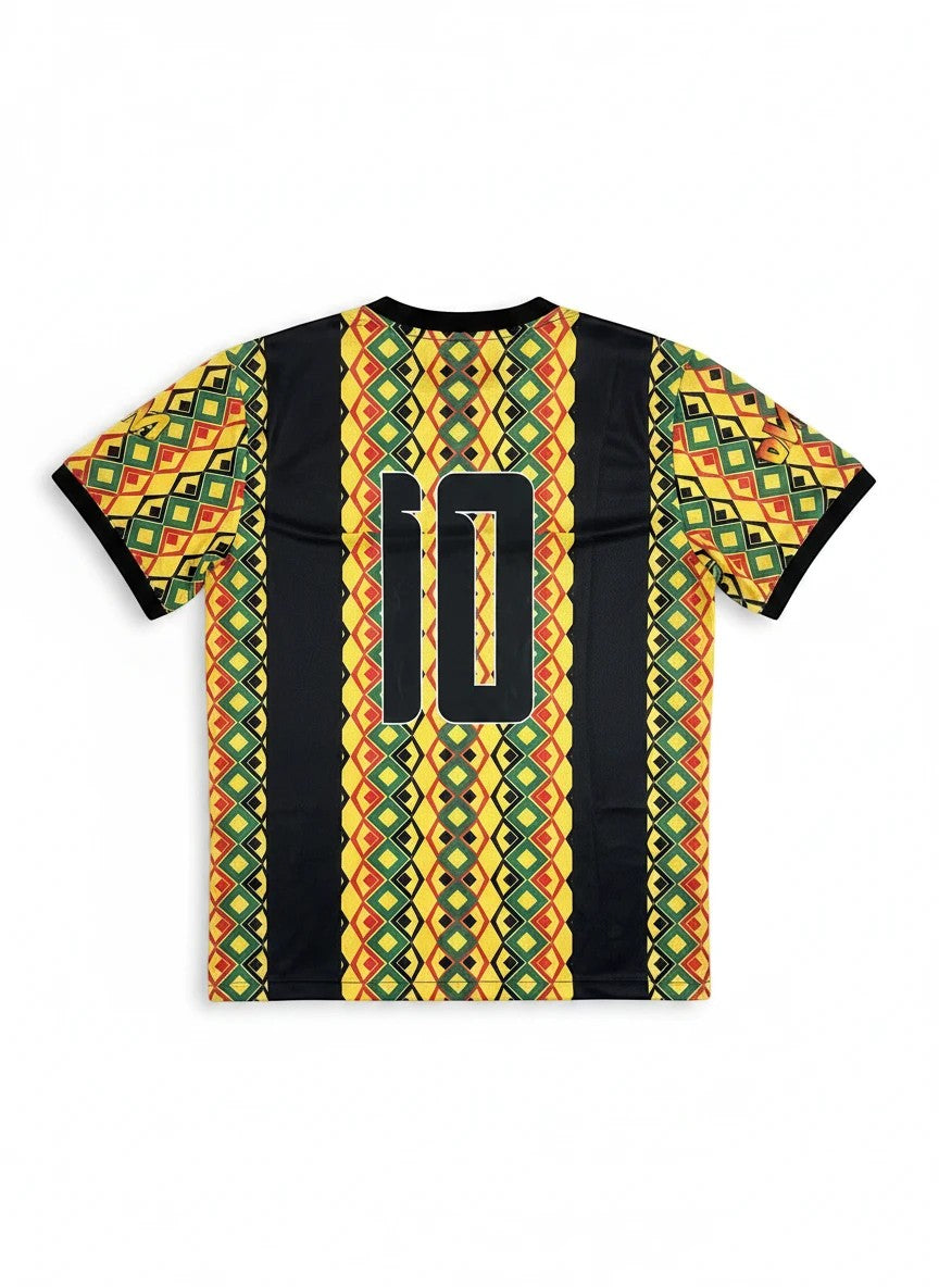 Throwback Rack Jamaica 1990 World Cup soccer jersey with geometric pattern in green, yellow, red, and black, featuring number 10 on back.