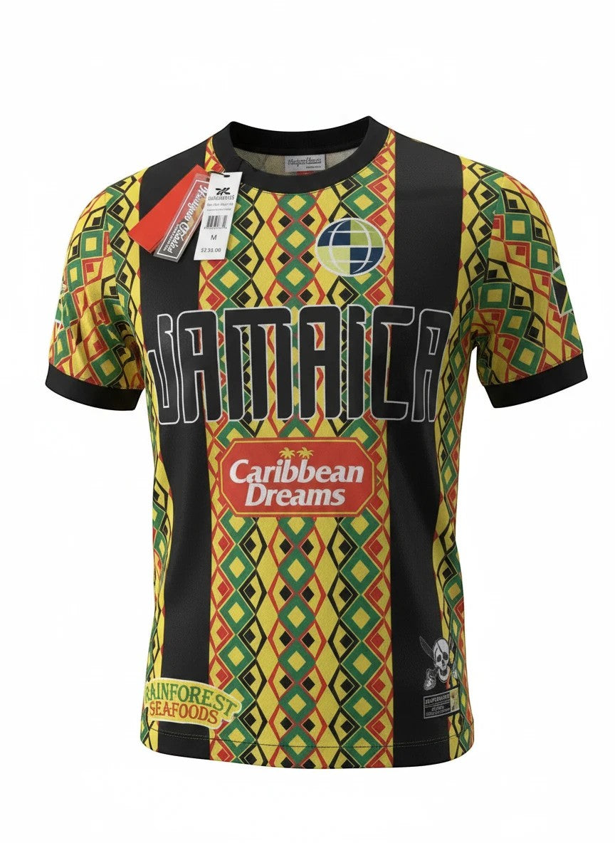 Throwback Rack JAMAICA 1990 World Cup retro soccer jersey with green, yellow, red geometric pattern and black panels. Features "JAMAICA" text and sponsor logos.
