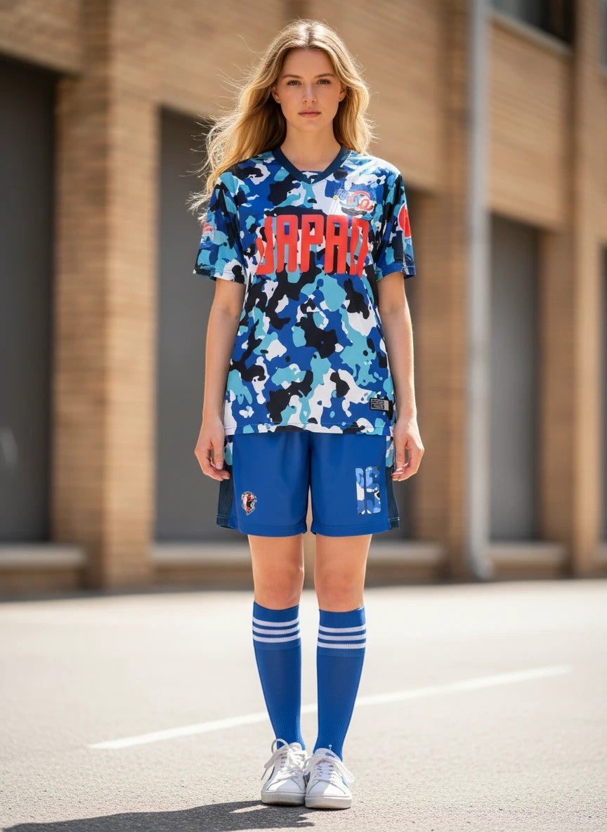 Throwback Rack Japan 1990 World Cup camouflage soccer jersey with blue, black, and white pattern. Features red "JAPAN" graphic.