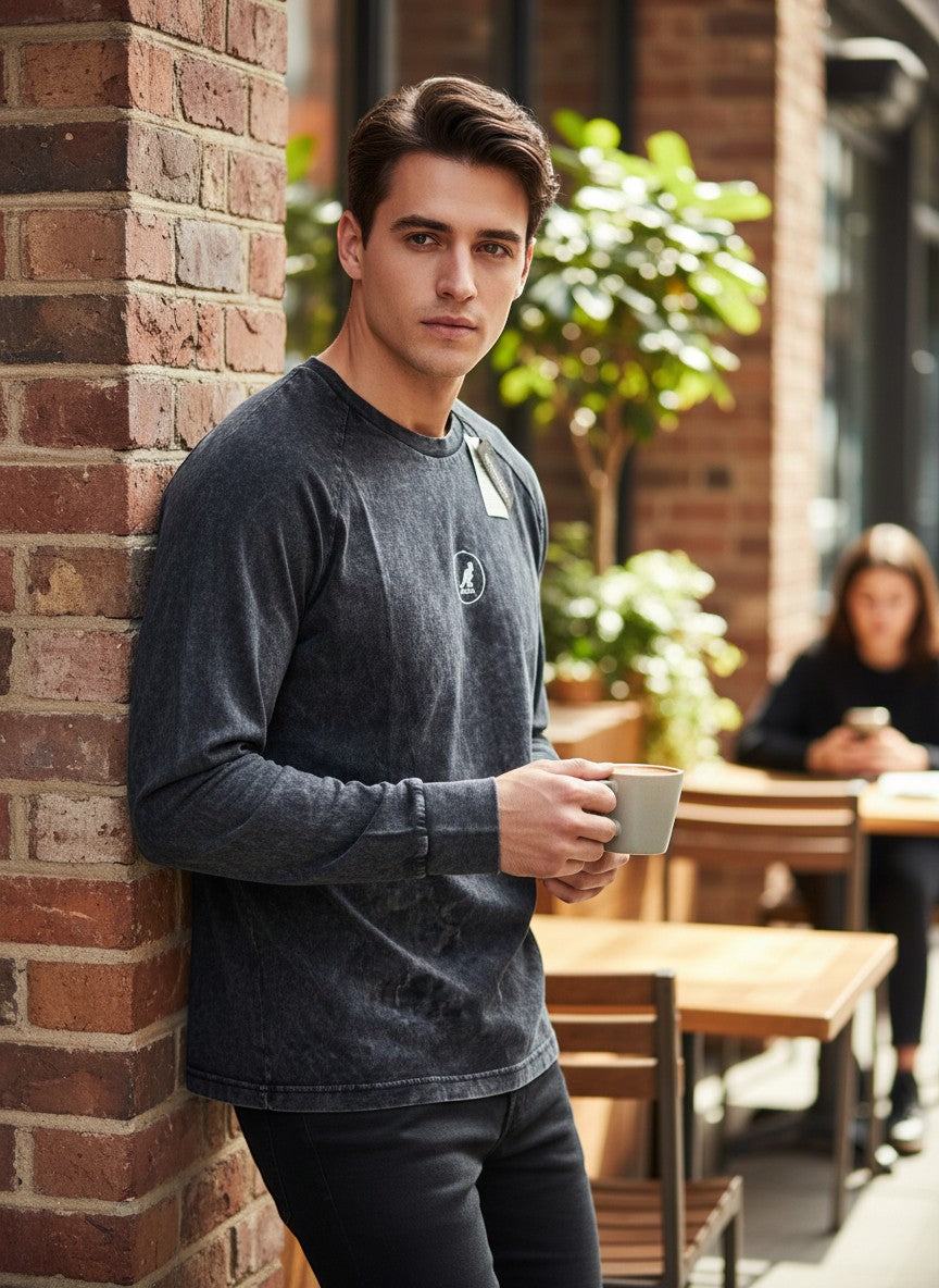 Throwback Rack Kangol dark acid wash long sleeve cotton shirt with subtle logo detail, worn by a man holding a coffee cup.