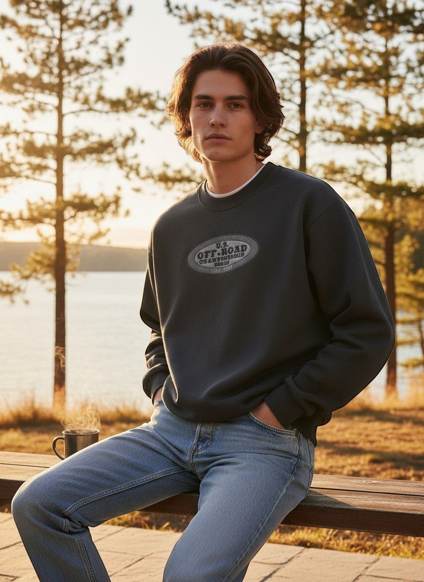 Throwback Rack dark grey crewneck sweatshirt with U.S. Off-Road Championship logo, worn by a man outdoors.