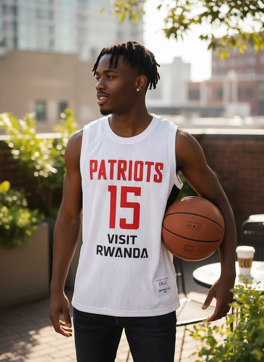 Throwback Rack white mesh basketball jersey with red "PATRIOTS" and "15" on front, "VISIT RWANDA" graphic, and "COLE 15" on back.