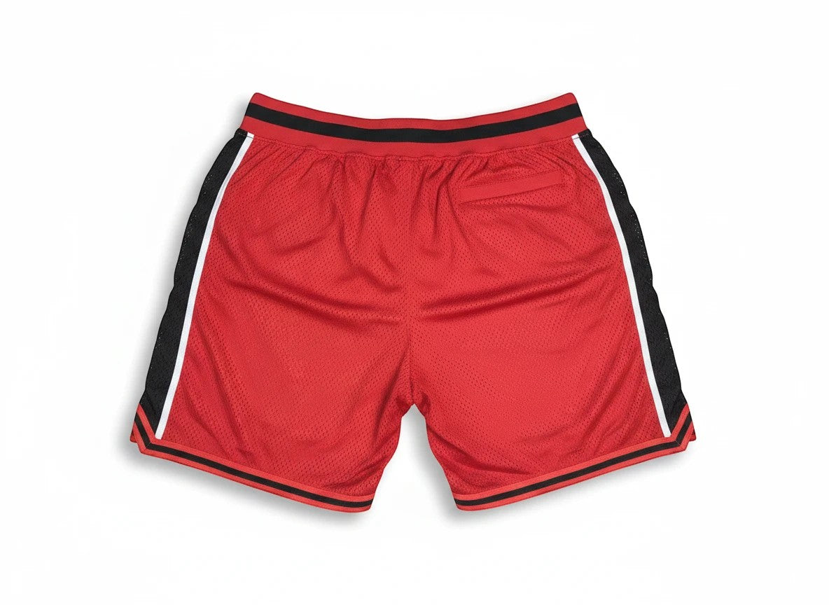 Throwback Rack red polyester basketball shorts with black and white side stripes and elastic waistband.