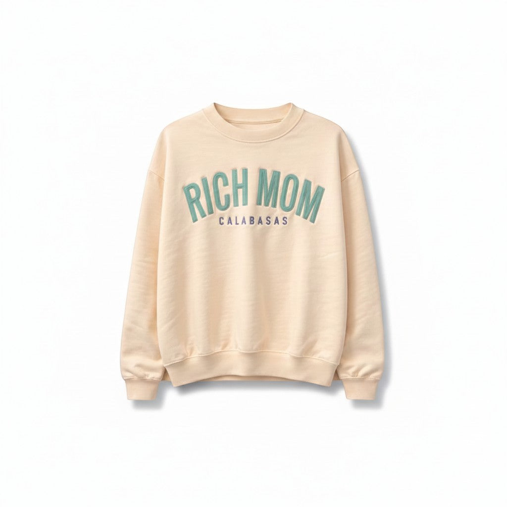 Throwback Rack peach crewneck sweatshirt with "RICH MOM CALABASAS" text in teal.