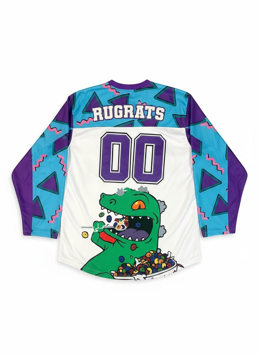 Throwback Rack Rugrats Reptar hockey jersey with purple and teal geometric pattern, white body, and Reptar graphic.