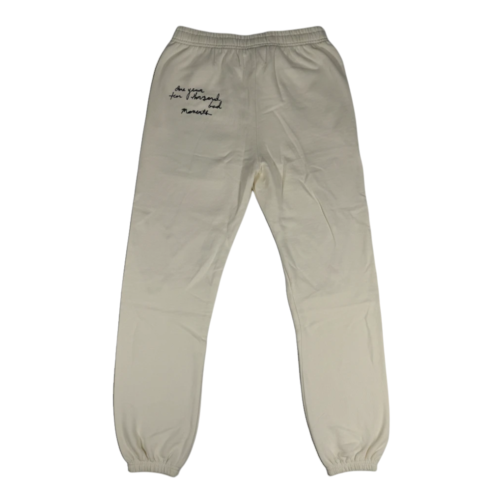 Throwback Rack cream-colored Sabrina Carpenter sweatpants with black cursive embroidery on the back pocket area.