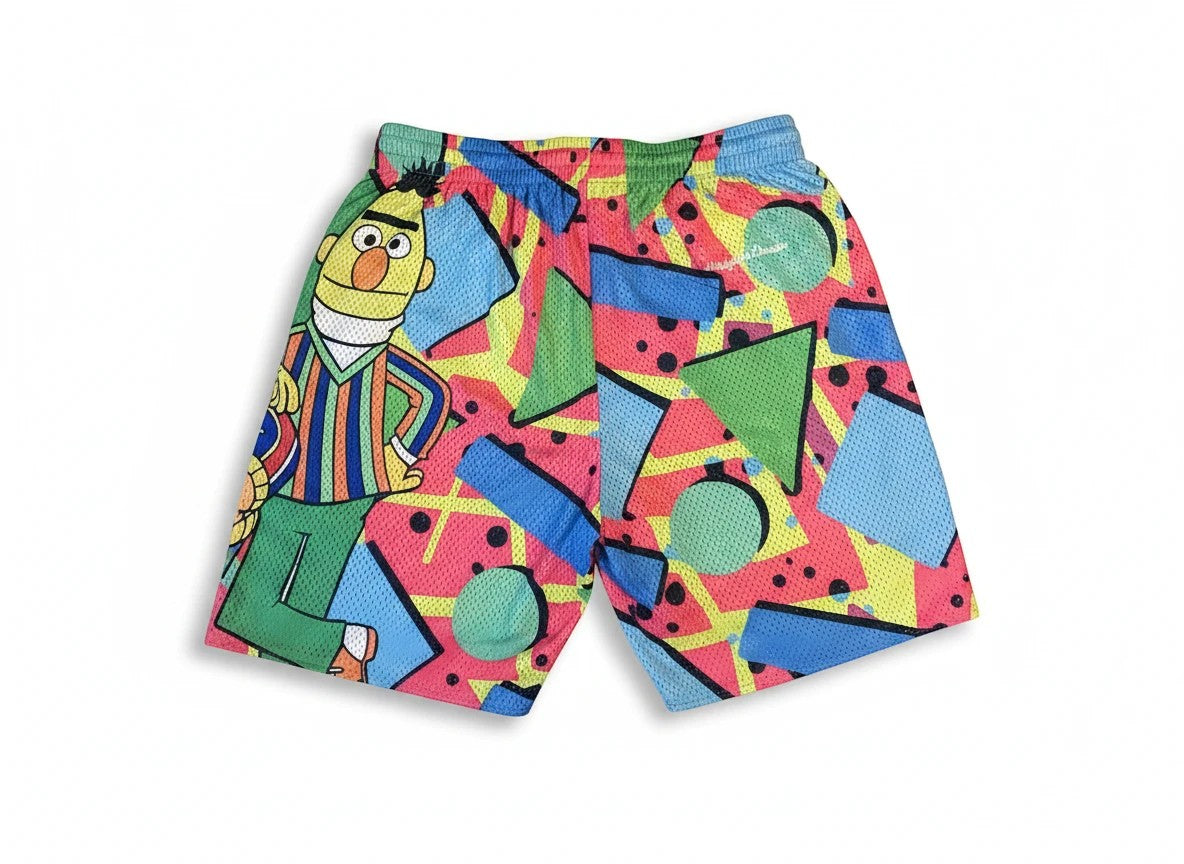 Throwback Rack Sesame Street basketball shorts featuring Bert and a colorful 90s-style geometric mesh pattern.