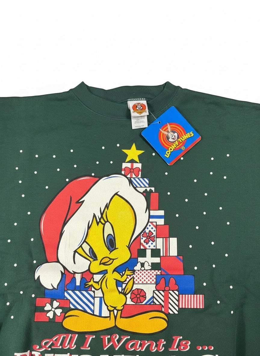 Throwback Rack green vintage Christmas sweatshirt with Tweety Bird wearing a Santa hat and standing by a gift-wrapped Christmas tree. Features white polka dots.