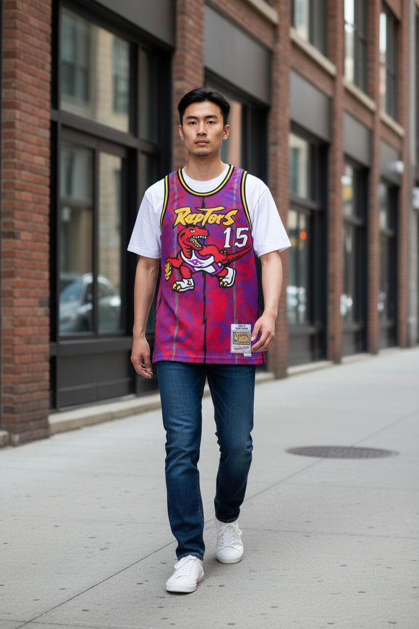 Throwback Rack Mitchell & Ness Toronto Raptors Vince Carter jersey in purple mesh with dinosaur graphic on a model