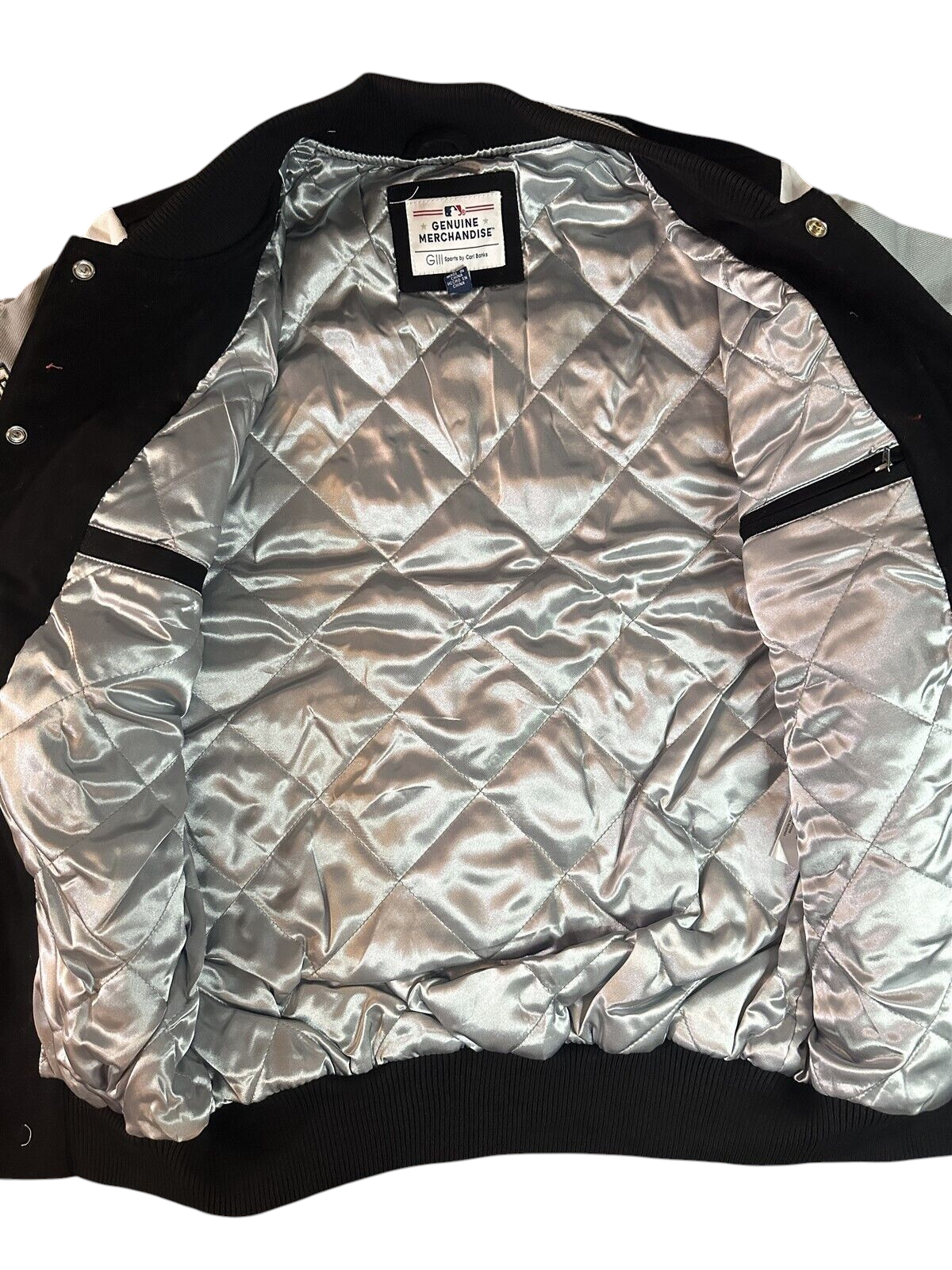 Throwback Rack Chicago White Sox varsity jacket interior featuring a silver quilted satin lining and snap buttons.