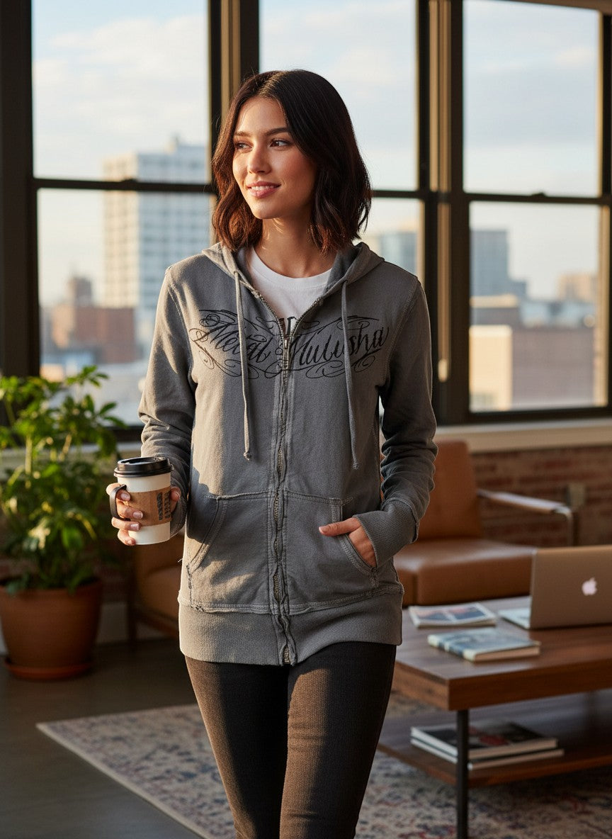 Throwback Rack grey Metal Mulisha zip-up hoodie with graphic logo on chest. Model is wearing a white t-shirt underneath.